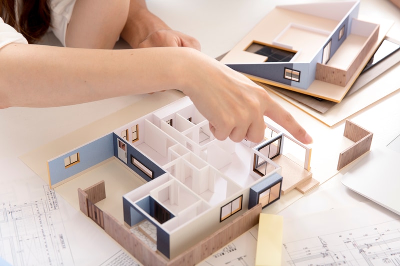 pointing over a building prototype